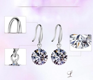 Detail view of 925 silver earring hooks and brilliant round cut zircon with hearts and arrows