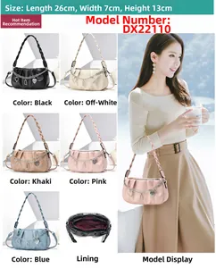 Detailed view of pleated PU leather bag with heart pendant and woven handle, 26x7x13cm