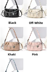 Detail view of stylish pleated shoulder bags in black, beige, khaki and pink colors