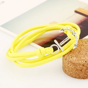 Detail of yellow braided PU leather nautical bracelet with silver anchor buckle