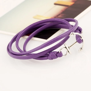 Detail of purple leather wrap bracelet featuring a silver metallic anchor charm clasp