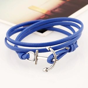 Macro detail of nautical PU leather bracelet with silver anchor clasp and blue cords