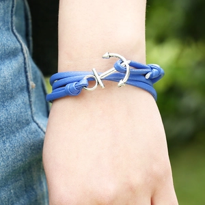 Detail view of blue leather wrap bracelet with silver anchor clasp on a wrist