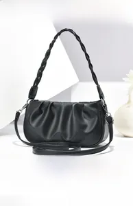 Detail view of black cloud pleated handbag with braided handle and silver hardware