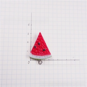Detailed view of resin watermelon slice charm with metal ring for DIY jewelry crafts