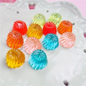 Macro shot of colorful resin jelly candies with spiral texture on a decorative plate