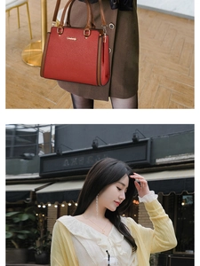 Detail of red lychee textured leather handbag with brown handles and gold logo accents