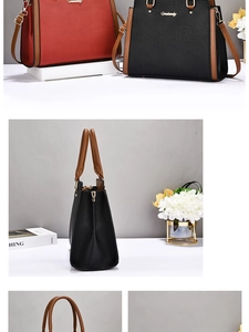 Detail of lychee textured leather tote bag with brown handles and gold hardware