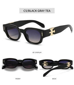Detailed side view of oval sunglasses with golden eagle relief and sword temple accents