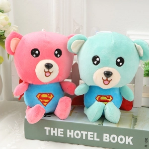 Detail of cute bear plush toys in pink and mint green with superhero capes and logos