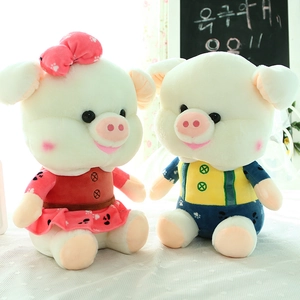 Macro shot of cute plush pig dolls in red spotted dress and yellow blue overalls