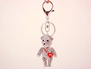 Close-up of silver crystal teddy bear keychain with red heart and lobster clasp