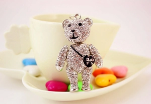 Silver rhinestone-studded bear keychain with black heart crossbody bag detail