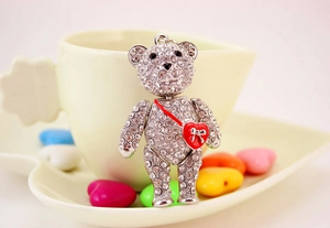Detail of a silver teddy bear keychain with sparkling rhinestones and a red heart charm