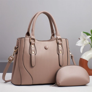 Elegant mauve two-piece handbag set with tote bag and pouch on a minimalist background