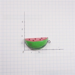 Detailed macro view of artificial resin watermelon slice charm with metal jump ring