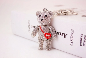 Macro view of silver bear keychain with sparkling rhinestones and a red bow heart detail