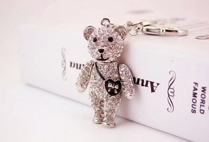 Detail of silver bear keychain with sparkling rhinestones and black heart bag charm
