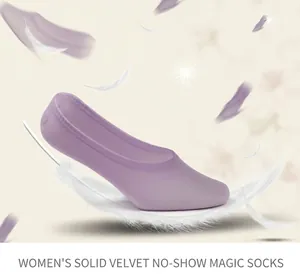 Macro detail of lightweight purple velvet magic socks resting on a soft white feather
