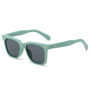 Square mint green sunglasses with dark grey lenses and gold arrow studs on white background