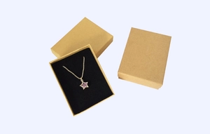 Star pendant necklace with purple gemstone in kraft paper jewelry gift box detail