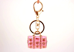 Detailed view of pink handbag keychain with heart shaped rhinestones and gold clasp