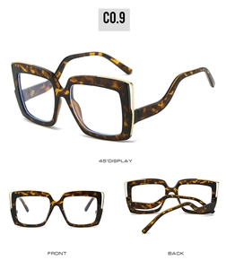 Detail view of square tortoiseshell glasses with gold metal accents and curved temples