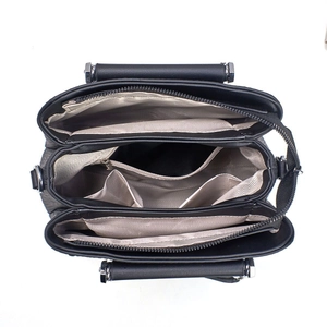 Internal view of the handbag featuring multiple compartments and a herringbone lining