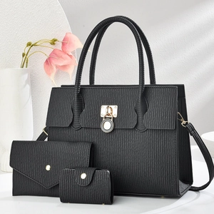 Three-piece set of black textured handbags with gold metal hardware and round twist lock