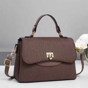 Deep brown pleated leather handbag with gold twist lock and adjustable shoulder strap