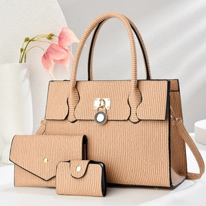 Detailed set of three apricot pleated handbags with golden hardware and elegant texture