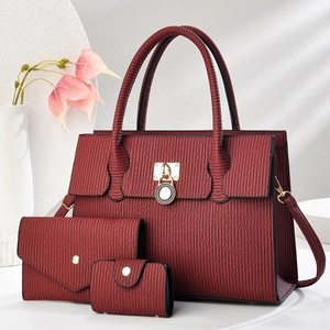 Detailed view of wine red handbag set with wave texture and golden metal lock