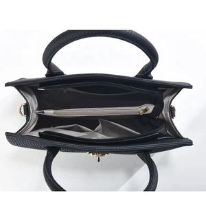 Detailed top view of the black handbag showing multi-functional interior compartments