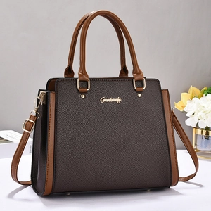 Litchi pattern vintage leather handbag with contrasting brown tones and gold hardware