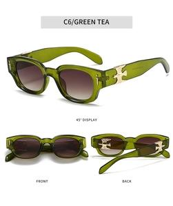 Detailed views of oval sunglasses with green tea frames and golden bird metal ornaments