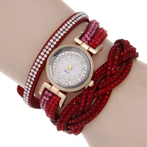 Close-up of red multi-layer wrap watch with sparkling crystals and golden quartz dial