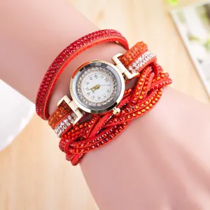 Detail of a wrap-around leather watch band with vibrant red and orange crystal rhinestones