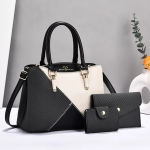 Detailed set of white and black tote bag, envelope clutch, and mini wallet with gold lettering