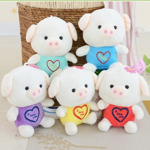 Close-up of five colorful plush toy pigs with I love you heart embroidery details