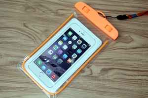Close-up of clear PVC waterproof phone pouch with secure orange locking seal and lanyard