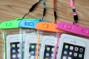 Macro shot of waterproof phone pouches in four neon colors with secure sliding locks