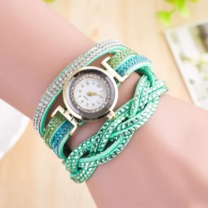 Detail of mint green wrap bracelet watch with sparkling rhinestones and gold-tone case