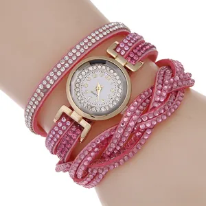 Detail of pink multi-layer wrap watch with sparkling rhinestones on leather strap