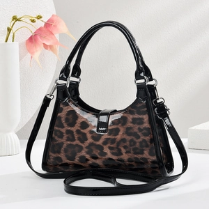 Detail of glossy leopard print crescent bag with black leather trim and silver hardware