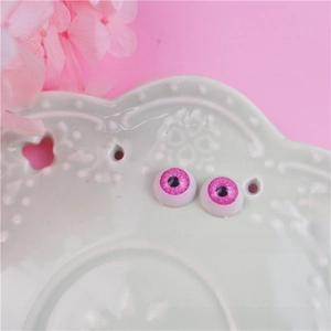 Macro shot of 12mm pink BJD doll eyes with bionic textures for DIY craft accessories