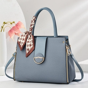 Blue vintage textured handbag with gold hardware and a stylish houndstooth scarf handle