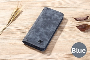 Gros plan du portefeuille long bleu en cuir dépoli avec logo embossé sur bois