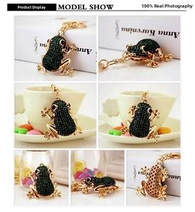 Detail view of green rhinestone frog keychain with gold metal mesh and red gem eyes