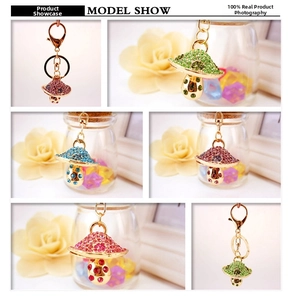 Detail showing various colors of rhinestone mushroom keychains with gold lobster clasps