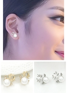 Détails macro des boucles d'oreilles bois de cerf avec perles et zircons micro-incrustés